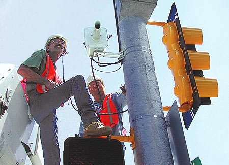 men installing OHVDS system